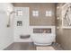 A luxury bathroom featuring a soaking tub, shower, and stylish tiled accents at 2129 E Beautiful Ln, Phoenix, AZ 85042