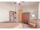 Neutral bedroom featuring a rocking chair, wood floors, closet, and reading nook at 2129 E Beautiful Ln, Phoenix, AZ 85042