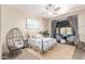 A serene bedroom features a cozy wicker chair and beach themed decor at 2129 E Beautiful Ln, Phoenix, AZ 85042