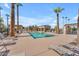 Relaxing community pool surrounded by tall palm trees, lounge chairs, and shaded areas for resident enjoyment at 2129 E Beautiful Ln, Phoenix, AZ 85042
