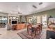 Spacious open-concept living area with dining table, stone fireplace and plenty of natural light at 2129 E Beautiful Ln, Phoenix, AZ 85042