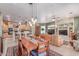 Open dining area showcasing the kitchen, living room, and stylish pendant lighting at 2129 E Beautiful Ln, Phoenix, AZ 85042