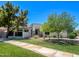 Charming single-story home featuring a well-maintained lawn and mature trees providing ample shade at 2129 E Beautiful Ln, Phoenix, AZ 85042