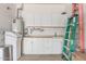 Well-organized garage with cabinets, countertops, sink, and a ladder for projects at 2129 E Beautiful Ln, Phoenix, AZ 85042