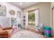 Comfortable home office features natural light, a colorful rug, a work chair, and decorative art at 2129 E Beautiful Ln, Phoenix, AZ 85042