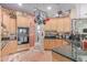 A spacious kitchen with stainless steel appliances, granite countertops, and hanging pot rack at 2129 E Beautiful Ln, Phoenix, AZ 85042