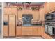 An open kitchen with wooden cabinets, stainless steel appliances, and granite countertops at 2129 E Beautiful Ln, Phoenix, AZ 85042