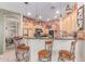 A kitchen with wooden cabinets, granite countertops, a breakfast bar, and stainless steel appliances at 2129 E Beautiful Ln, Phoenix, AZ 85042