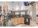 Open concept kitchen features granite countertops, stainless steel appliances, and pendant lighting at 2129 E Beautiful Ln, Phoenix, AZ 85042