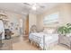 Spacious main bedroom featuring neutral tones, a ceiling fan, and an adjacent bathroom at 2129 E Beautiful Ln, Phoenix, AZ 85042
