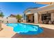 Sparkling backyard pool featuring a tanning ledge and surrounding concrete patio at 2129 E Beautiful Ln, Phoenix, AZ 85042