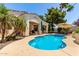 Backyard pool surrounded by lush greenery and patio area at 2129 E Beautiful Ln, Phoenix, AZ 85042