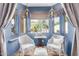 Cozy sitting area with blue walls, comfortable seating, and natural light at 2129 E Beautiful Ln, Phoenix, AZ 85042