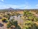 Beautiful aerial view of lush community with lake, mature landscaping and mountain views at 2234 N 74Th Way, Scottsdale, AZ 85257