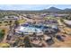 Community aerial view showcasing a pool and nearby amenities with a mountain in the background on a clear day at 2234 N 74Th Way, Scottsdale, AZ 85257