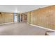 Basement area featuring wood paneled walls, light floors, and multiple doorways to adjacent rooms at 2234 N 74Th Way, Scottsdale, AZ 85257
