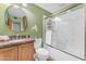 Bathroom featuring granite counters, a round mirror, and a glass-enclosed shower at 2234 N 74Th Way, Scottsdale, AZ 85257