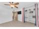 Bedroom featuring an open closet, a ceiling fan, and light colored laminate flooring at 2234 N 74Th Way, Scottsdale, AZ 85257