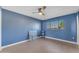 A cozy blue bedroom with a ceiling fan and a window at 2234 N 74Th Way, Scottsdale, AZ 85257