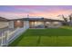 Inviting single-story home with well-kept lawn, neutral stucco, brick accents and small seating area at 2234 N 74Th Way, Scottsdale, AZ 85257