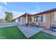 Cozy home featuring manicured yard, a brick facade, and a charming seating area on the front patio at 2234 N 74Th Way, Scottsdale, AZ 85257