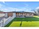 Charming single-story home featuring a well-maintained lawn, brick accents, and a classic white picket fence at 2234 N 74Th Way, Scottsdale, AZ 85257