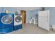 Combination laundry room and half bath, features newer appliances and white tile flooring at 2234 N 74Th Way, Scottsdale, AZ 85257