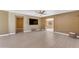 Living room with neutral paint, light floors, and multiple entryways to other rooms, and a wall-mounted TV at 2234 N 74Th Way, Scottsdale, AZ 85257