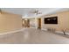 Living room with neutral paint, light floors, and multiple entryways to other rooms, and a wall-mounted TV at 2234 N 74Th Way, Scottsdale, AZ 85257