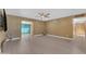 Spacious living room with neutral paint, ceiling fan, and light wood-look floors, with views to an adjacent room at 2234 N 74Th Way, Scottsdale, AZ 85257