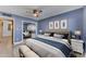 Relaxing main bedroom featuring blue walls, ceiling fan, art decor and sliding mirror closet at 2234 N 74Th Way, Scottsdale, AZ 85257