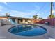 Backyard pool featuring a slide and lounge seating, surrounded by a well-kept brick privacy wall and blue skies at 2234 N 74Th Way, Scottsdale, AZ 85257