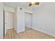 Neutral bedroom with closet, ceiling fan, and light wood flooring throughout at 2706 W Isabella Ave, Mesa, AZ 85202