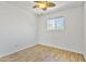 This bedroom features a ceiling fan and a window to provide natural light at 2706 W Isabella Ave, Mesa, AZ 85202