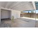Covered carport with white ceiling, string lights and storage, next to the backyard wall at 2706 W Isabella Ave, Mesa, AZ 85202