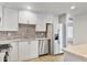 Updated kitchen featuring stainless steel appliances, tile backsplash, and modern finishes at 2706 W Isabella Ave, Mesa, AZ 85202