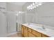 Bathroom featuring a double vanity, shower, and large framed mirror with modern lighting at 2861 E Morenci Rd, San Tan Valley, AZ 85143