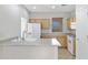 Well-lit kitchen featuring oak cabinets, white appliances, and a breakfast bar at 2861 E Morenci Rd, San Tan Valley, AZ 85143