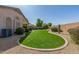Expansive backyard with lush artificial turf, desert landscaping, and privacy wall at 29049 N Coal Ave, San Tan Valley, AZ 85143