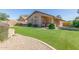 View of backyard with artificial turf, mature shrubs, and patio area with sun protection at 29049 N Coal Ave, San Tan Valley, AZ 85143