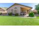 Well-maintained backyard featuring artificial turf, desert landscaping, and covered patio at 29049 N Coal Ave, San Tan Valley, AZ 85143