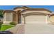 Charming single-story home featuring a two-car garage and a well-maintained landscaped front yard at 29049 N Coal Ave, San Tan Valley, AZ 85143