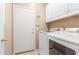 Well-equipped laundry room with modern washer, dryer, and ample cabinet space at 29049 N Coal Ave, San Tan Valley, AZ 85143
