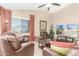 Bright living room with tile floors, ceiling fan, comfortable leather chairs, and a TV for entertainment at 29049 N Coal Ave, San Tan Valley, AZ 85143