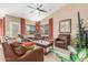Comfortable living room with plush leather seating, a ceiling fan, and natural light at 29049 N Coal Ave, San Tan Valley, AZ 85143