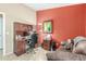 Office space with a wooden desk and chair and a lounge area with a small couch at 29049 N Coal Ave, San Tan Valley, AZ 85143