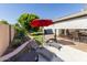 Private backyard features a sparkling pool, covered patio, and manicured landscaping at 3061 W Betty Elyse Ln, Phoenix, AZ 85053