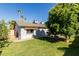 Well-kept backyard with lush green lawn, mature tree, and outdoor grilling and seating area, perfect for entertaining at 3061 W Betty Elyse Ln, Phoenix, AZ 85053