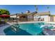 Backyard oasis with a sparkling pool, covered patio, and lush landscaping at 3061 W Betty Elyse Ln, Phoenix, AZ 85053