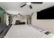 Bedroom boasts a large bed, adjacent workstation, and ample natural light, creating an inviting and versatile space at 3061 W Betty Elyse Ln, Phoenix, AZ 85053